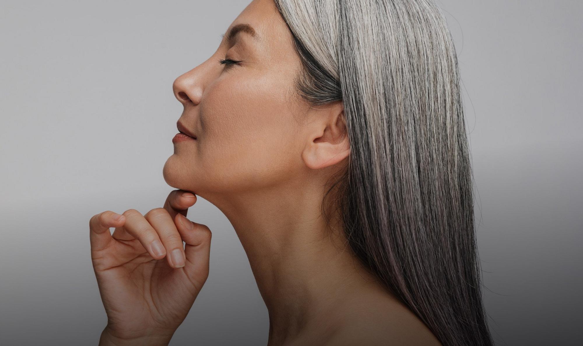 deep plane facelift patient model lifting her chin up with a finger