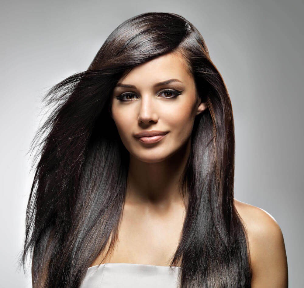 Woman with long brown hair smiling