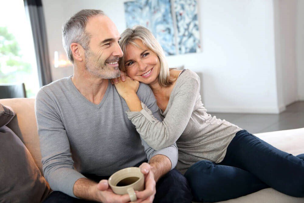 facelift patient model sitting next to her partner hugging him