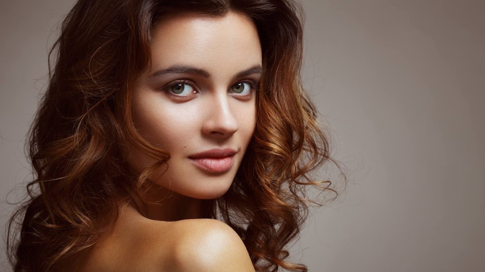 natural facelift patient model with curly brown hair