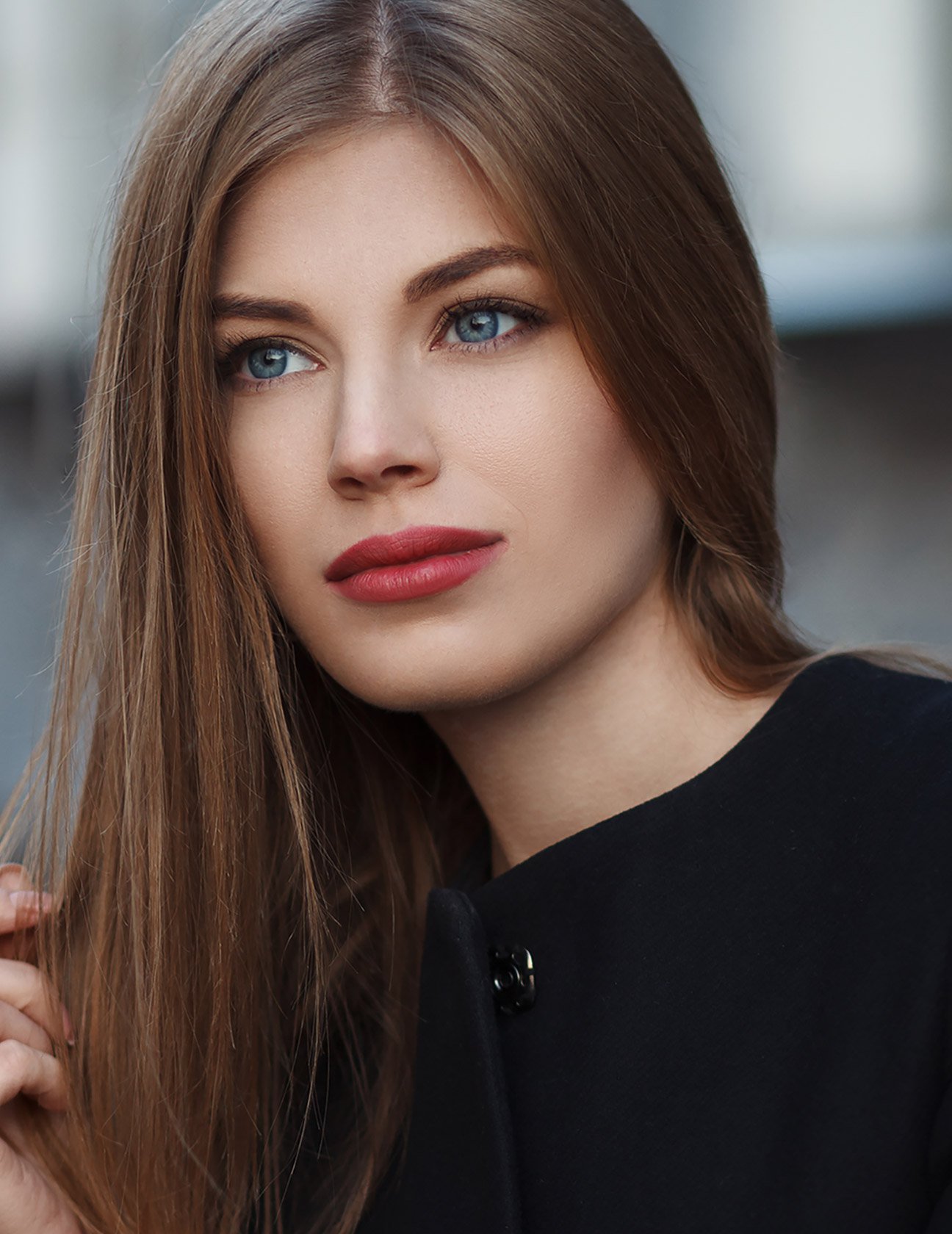 Coolsculpting patient model in a black coat wearing red lipstick